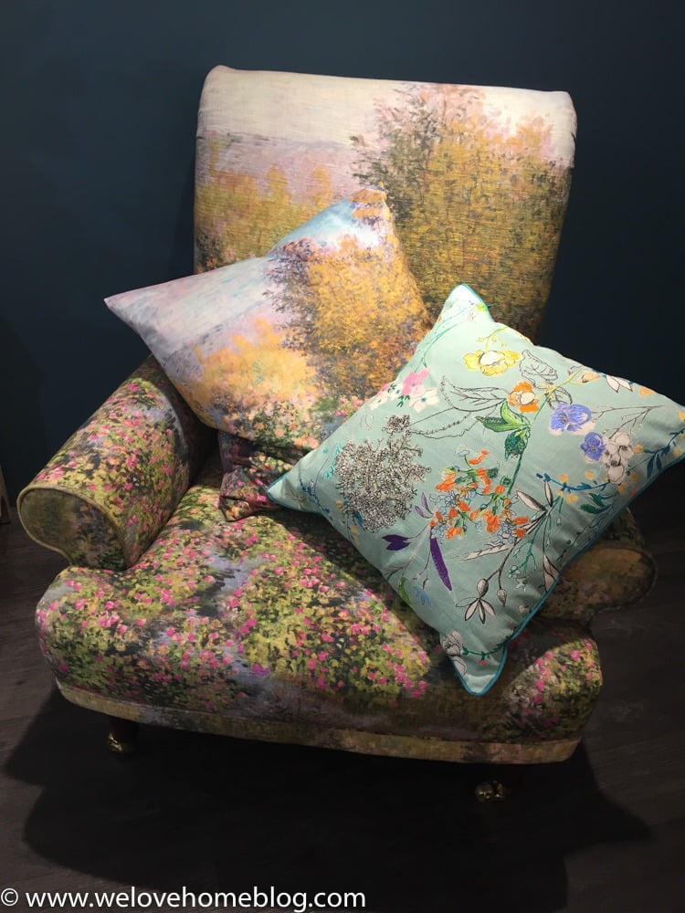Look at this wonderful chair upholstered with a print by artist Monnet. Just lush isn't it? Then see how they have layered up the embroidered cushions.