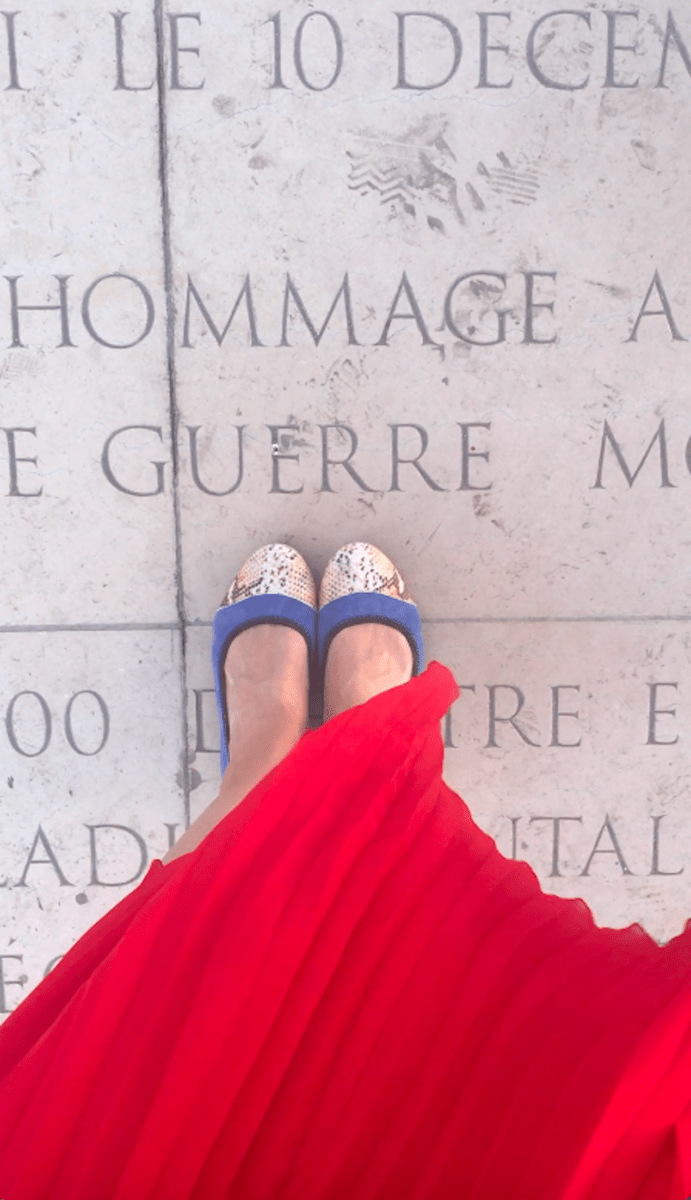 Maxine standing on a marble pavement in Paris
