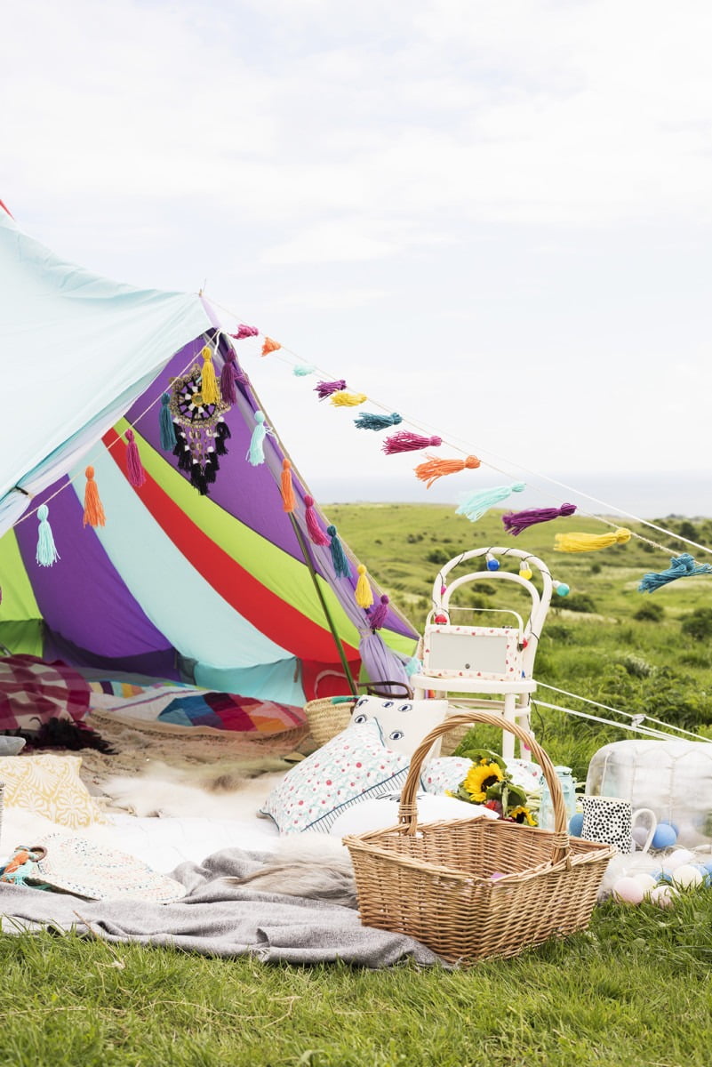 A colour tent set up in a green field