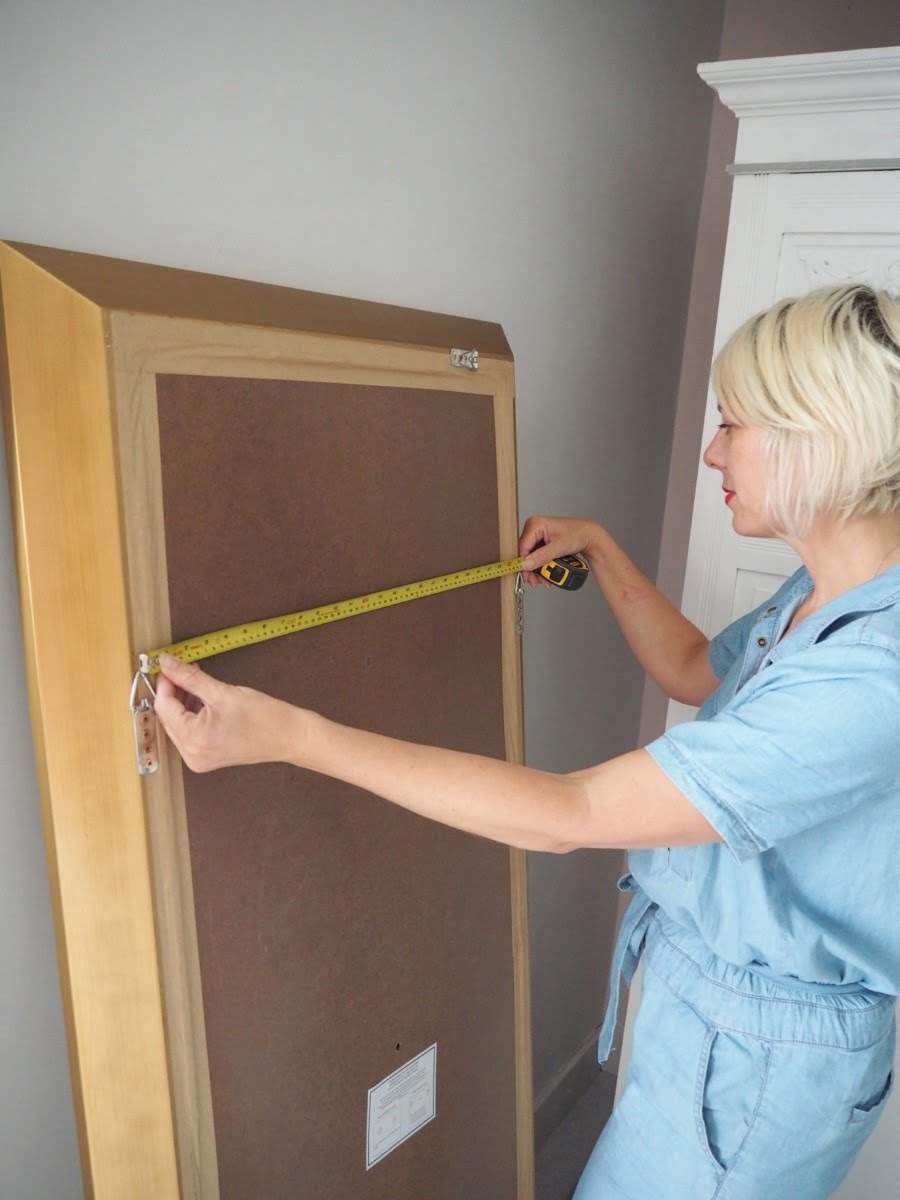 How to perfectly hang a mirror with just a few power tools, a jumpsuit and a bit of reddy lippy by Blogger + Interior Stylist Maxine Brady 