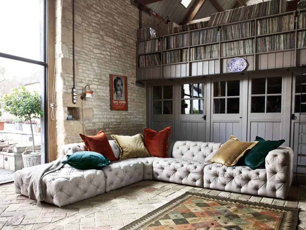 white chesterfield leather corner sofa large in barn home with crittal windows and record library 