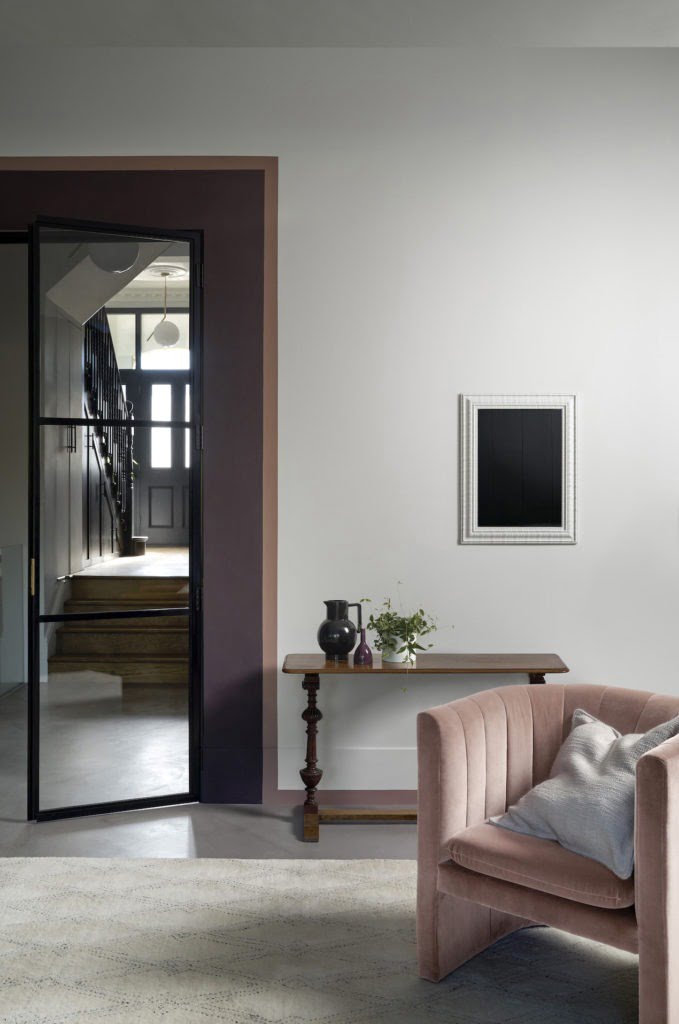door lipstick painted living room with pink purple walls and velvet armchair 