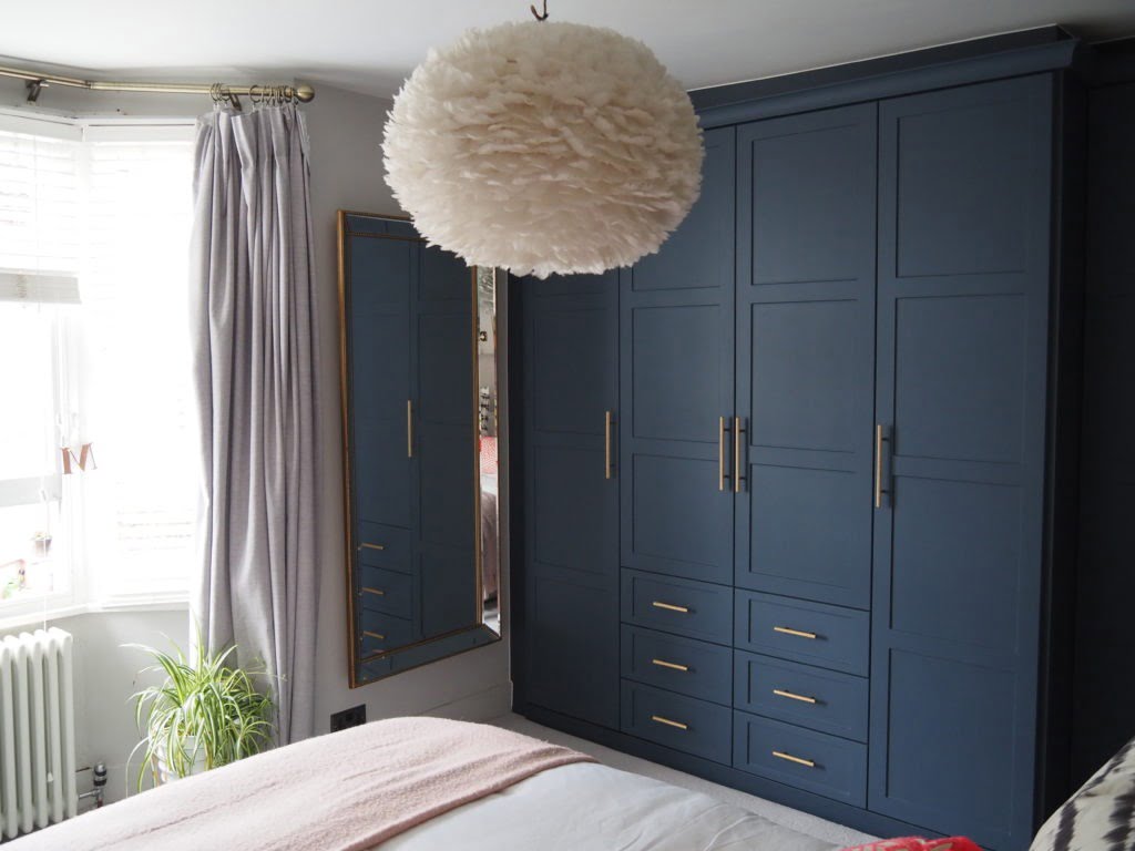 Step inside interior stylist Maxine Brady's cool bedroom redesign that is filled with clever storage ideas, pretty wallpaper and navy fitted wardrobes to create a dreamy room