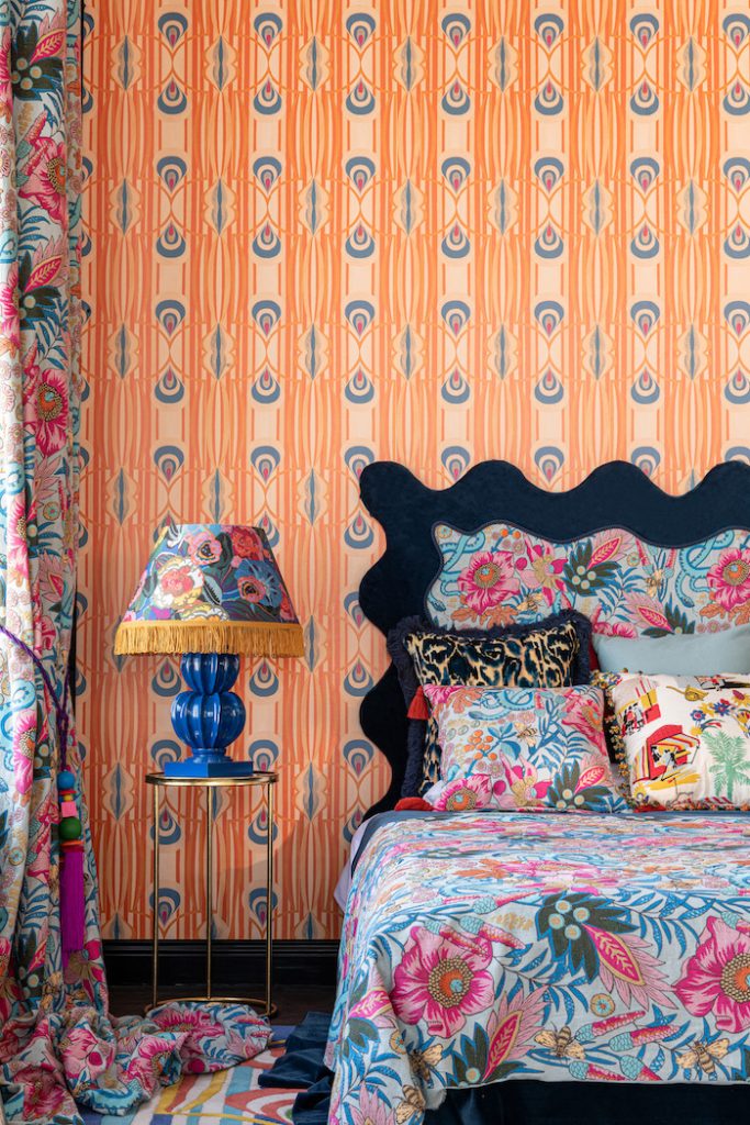 Top 9 questions to ask your contractors before hiring them for your next project.
Orange bedroom with wallpapered walls and upholstered headboard